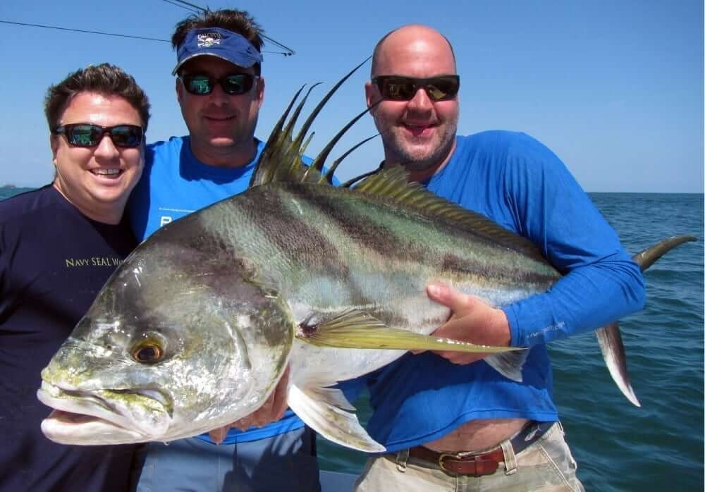 A roosterfish held boatside before release