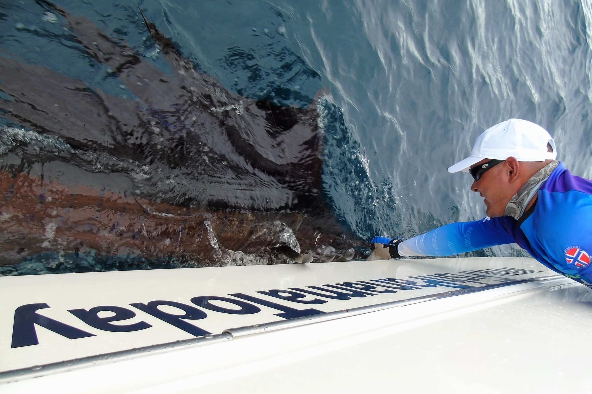 Angler with roosterfish boat side
